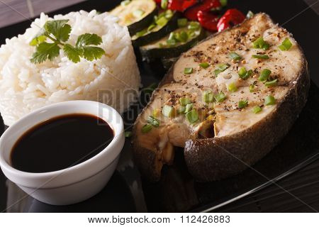 Baked Steak Of Fish And Rice On A Plate Close-up. Horizontal