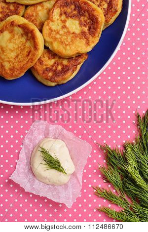 potato pancakes and garlic sauce on kraft paper
