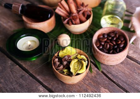 Beautiful spa setting on palm leaf on wooden table