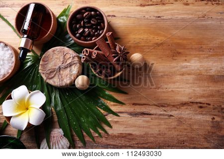 Beautiful spa setting on palm leaf on wooden table