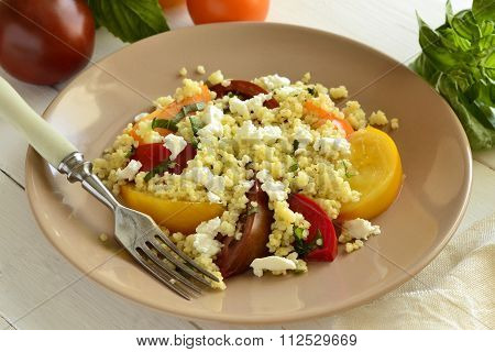 Millet with basil and fresh tomatoes and goat cheese