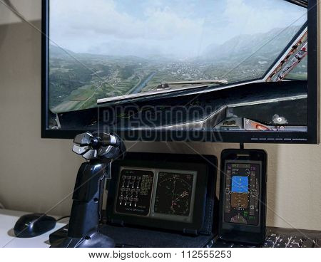 Hand on joystick, playing flight simulator