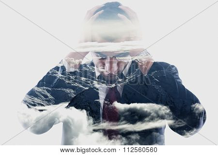double exposure of  a young business man looking depressed from work, relaxed mountain winter landscape in background