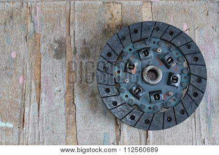 automobile clutch on wooden board