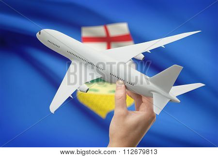 Airplane In Hand With Canadian Province Flag On Background - Alberta