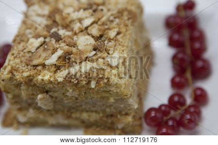 Close-up Fresh delicious diet cake with berry red currant at Dukan Diet on a porcelain plate with a spoon on a wooden background