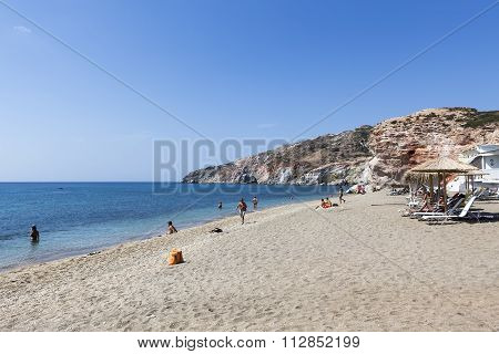 Tourists Enjoy The Clear Water Of The Beautiful Beach In Milos Island, Cyclades, Greece