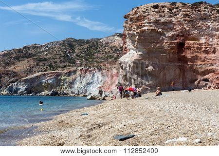 Tourists Enjoy The Clear Water Of The Beautiful Beach In Milos Island, Cyclades, Greece