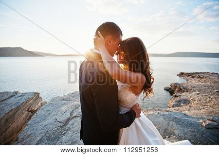 Very Sensual And Gorgeus Wedding Couple On The Picturesque Landscapes On Sunset