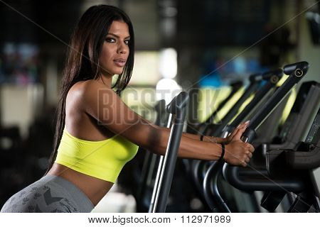 Mexican Women On Elliptical Treadmill In Fitness Gym