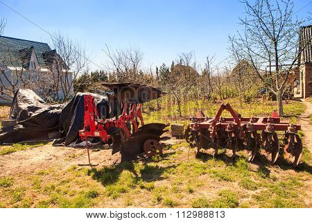 Large Tractor-drawn Plough Seeder In Country Garden In Spring