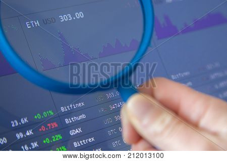 Paris, France - October 19, 2017 : Closeup With Magnifying Glass On Crypto Currencies With Many New