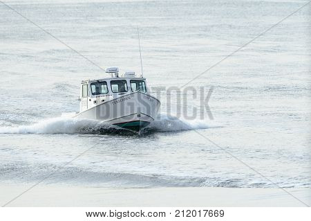 New Bedford Massachusetts USA - November 1 2017: Fishing boat Tenacious cutting through small chop in Buzzards Bay on way to New Bedford