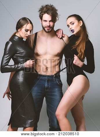 Man And Pretty Girls With Seductive Faces On Grey Background.