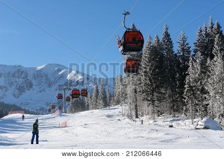 Jasna Slovakia - January 25 2017: Cableway and skiers on a sunny day on slopes in the ski resort of Jasna Low Tatras Slovakia.