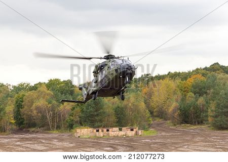 german military helicopter in flights over battlefield