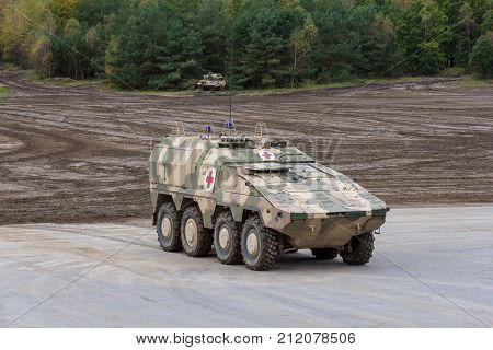 MUNSTER / GERMANY - OCTOBER 9 2017: German GTK Boxer medic version from Kmw and Rheinmetall stands on a platform near battlefield