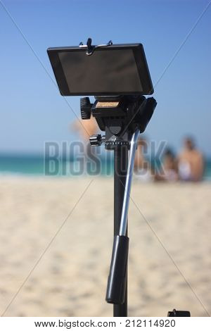 smartphone on a tripod. mobile equipment ready for shooting on the beach. modern device for video shooting