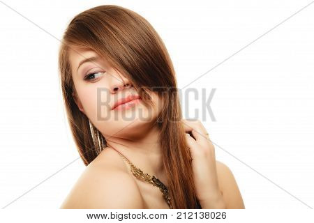 Luxury accessories. Face of young woman with bang covering her eye. Portrait of girl in golden necklace isolated on white.
