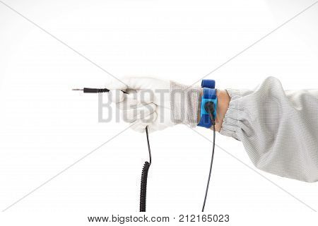Bracelet on the hand of a man wearing ESD cloth and glove static resistance (ESD) bracelet or ground equipment anti-static used to safely ground is working. electronic devices