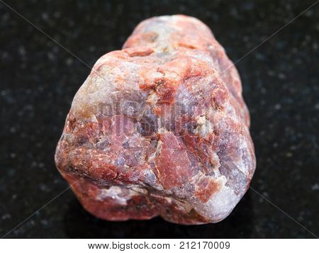 Pebble Of Pegmatite Stone On Dark Background