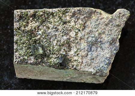 Rough Green Crystals Of Epidote On Rock On Dark