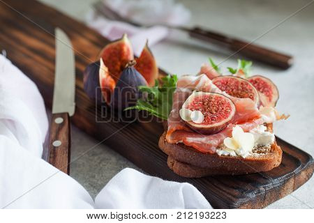 Sandwich With Ham, Ricotta Cheese And Figs On White Plate