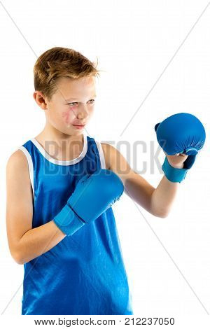 Pre-teen boxer boy with boxing gloves isolated against a white background