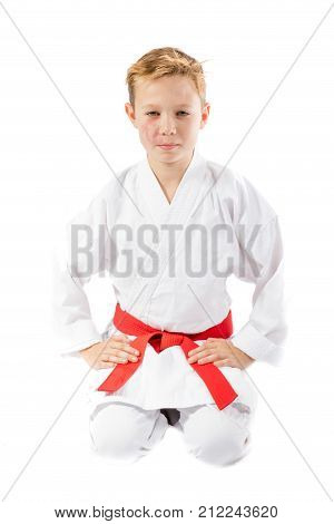 Pre-teen boy in martial arts uniform doing martial arts