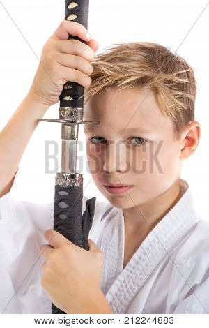 Pre-teen boy with a samurai sword isolated on a white background