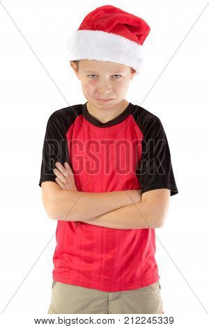 Pre-teen boy wearing a santa hat looking unhappy isolated on white