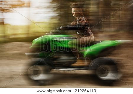 Woman On Atv. Picture Taken With Long Exposure And Mixed Light.