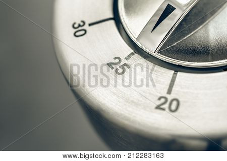 25 Minutes - Macro Of An Analog Chrome Kitchen Timer On Wooden Table
