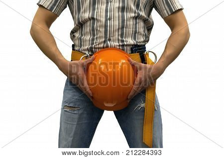 Builder construction worker in mounting belt covering his genitals with helmet isolated on white background. Construction. Repair concept. Safety sex funny concept.