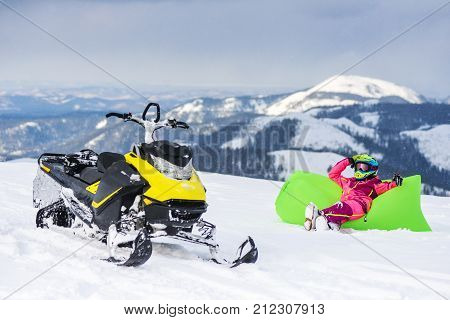 Rider on the snowmobile in the mountains ski resort in Amut Russia. The rider on the snowmobile in the mountains. the active drive. vacation in the mountains