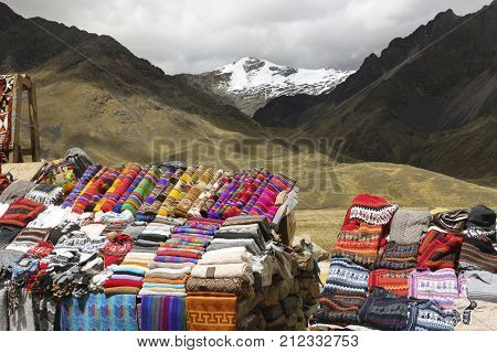 Scarves hats in traditional style of different colors on the market. The road Cusco-Puno Peru