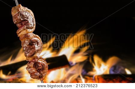 Picanha traditional Brazilian barbecue in fire background