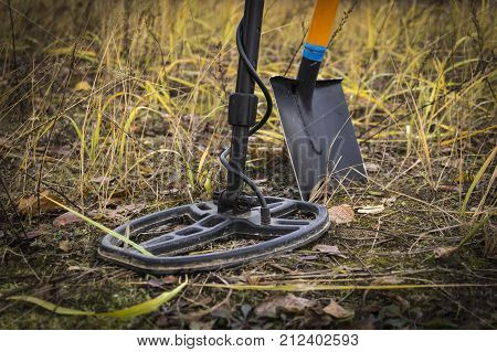 Treasure Searching With Metal Detector And Shovel On The Stubble Field