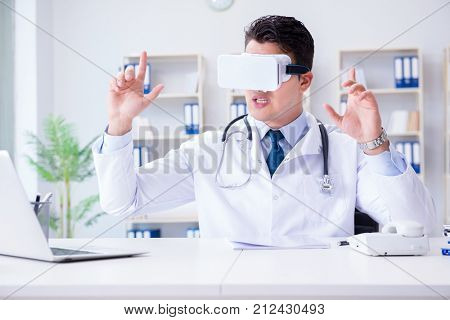 Young doctor with vr virtual reality headset working in the offi