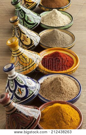 Diversity of Moroccan powder herbs in colorful ceramic tagines