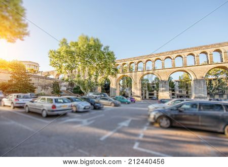View on the saint Clement aqueduct in Peyrou garden during the morning light in Montpellier city in southern France. Tilt-shift image technic with blurred cars