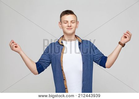 Harmony Concept. Boy Closed Eyes, Doing Yoga And Have A Happiness Look