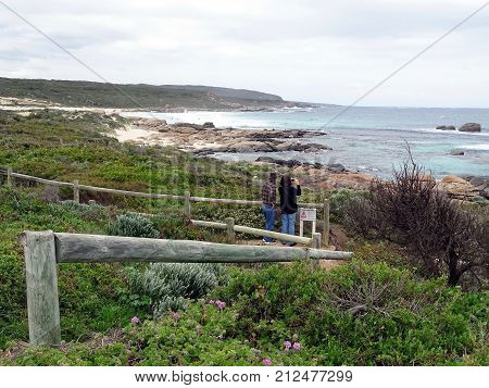 Two tourist taking a photo and enjoying the view towards the Indian Ocean in the southwest corner of Western Australia