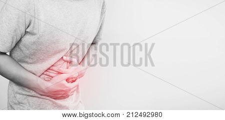 a man touching his stomach, red highlight concept of stomach pain and others stomach disease, on white background with copy space