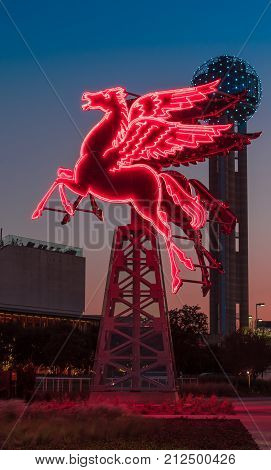 Pegasus neon sign lit up at sunset