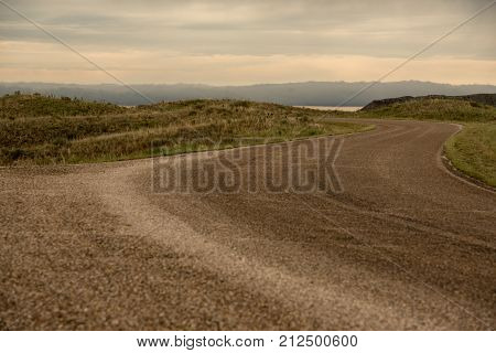 Winding highway in the plains of west texas in the evening on a cloudy day