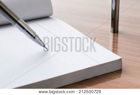 Writing on blank paper on wooden table