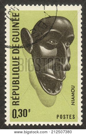 MOSCOW RUSSIA - CIRCA OCTOBER 2017: a post stamp printed in GUINEA shows a traditional mask the series "The masks" circa 1967