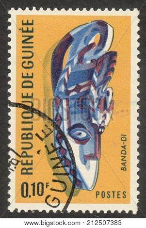 MOSCOW RUSSIA - CIRCA OCTOBER 2017: a post stamp printed in GUINEA shows a traditional mask the series 