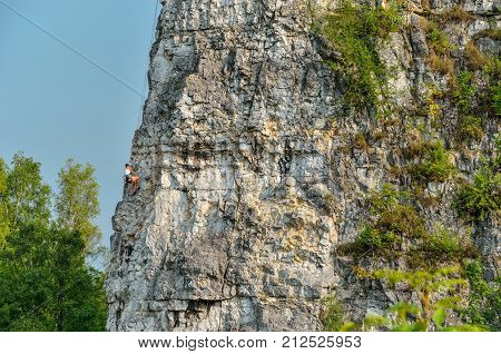 Beautiful rocky summer landscape. Climber on the rocks of Twardowski at the lagoon of Zakrzowek in Krakow Poland.